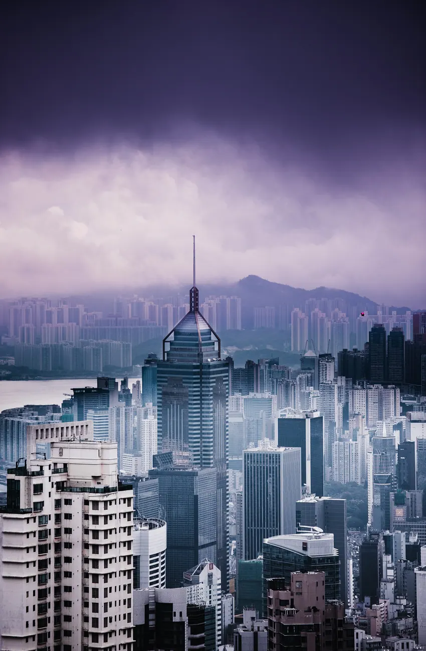 Hong Kong towers below a violet-gray sky