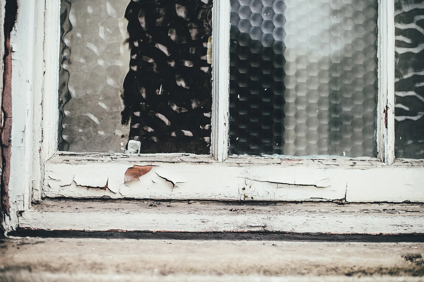 Weathered window and stone sill in Manchester
