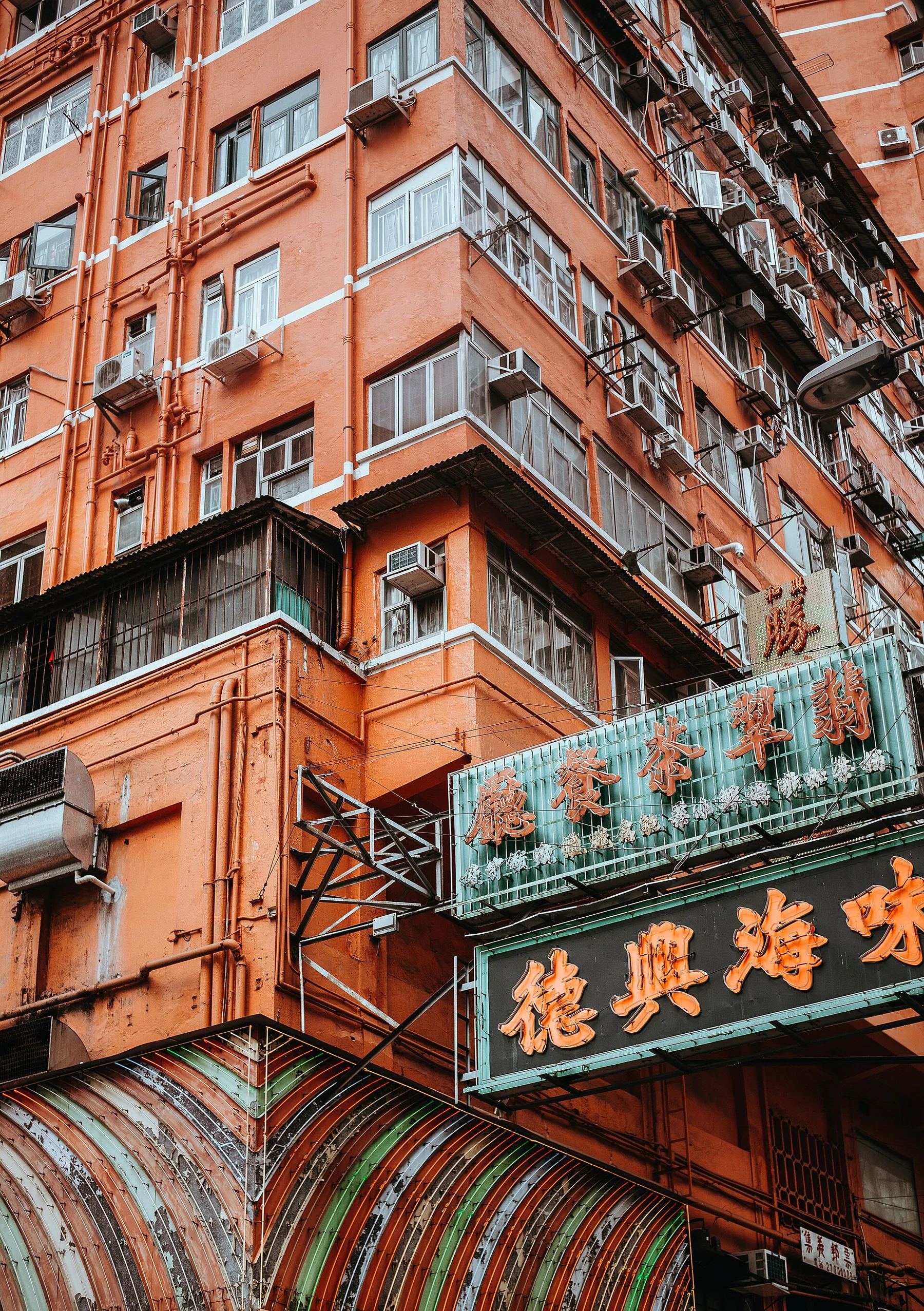 Warm brick facade with signs and windows in Hong Kong