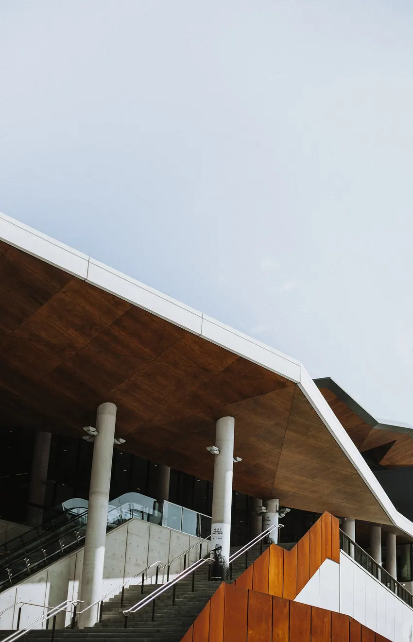 Staircase beneath an angular timber roof